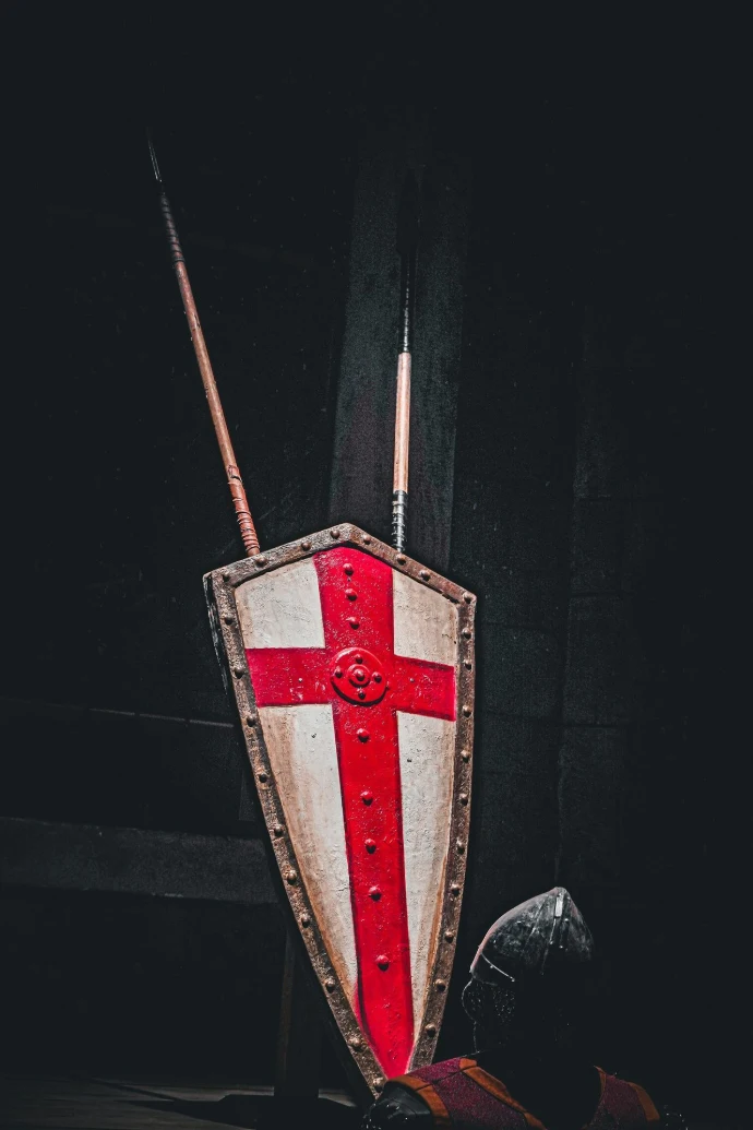A red and white shield with a red cross on it